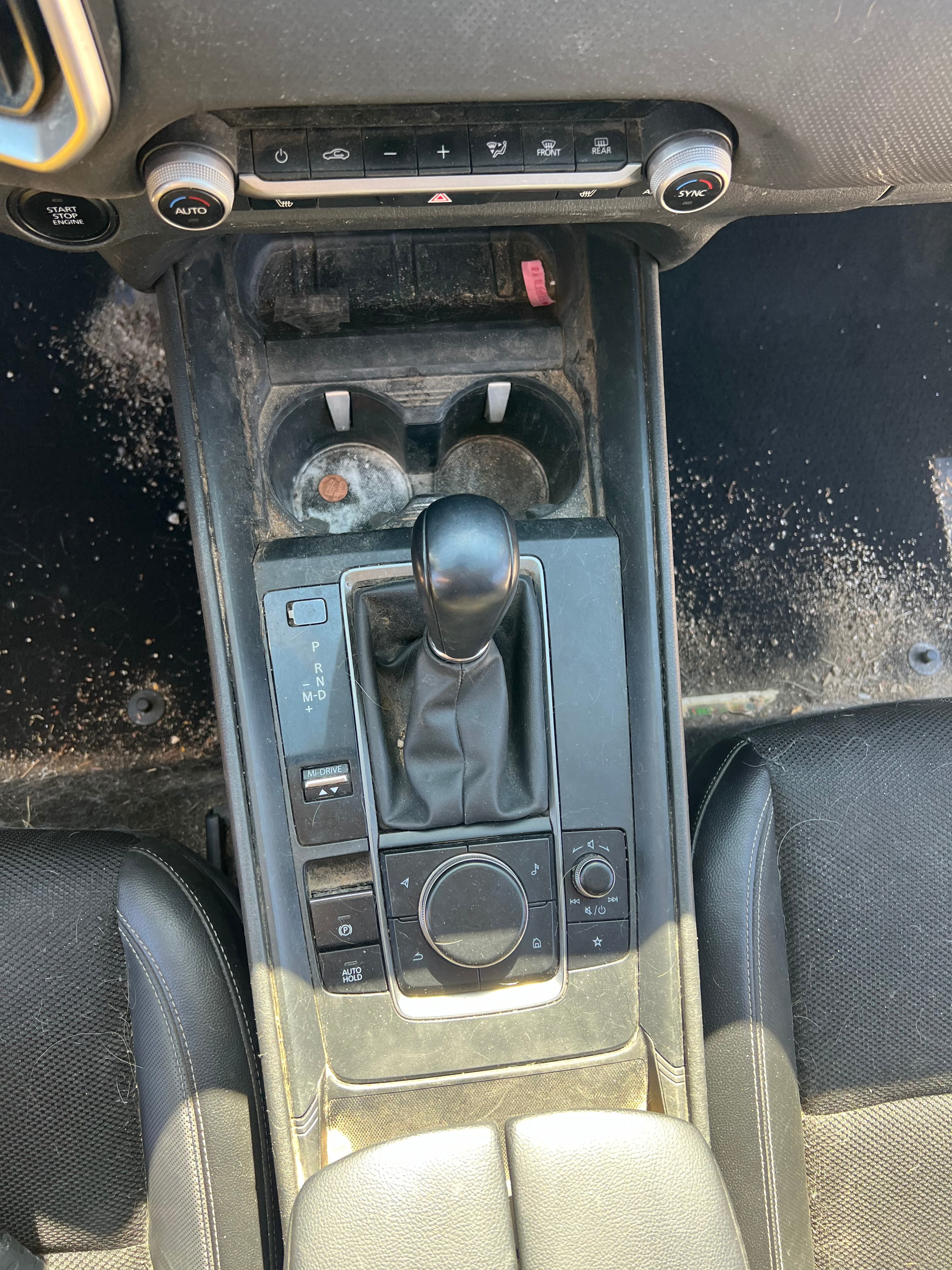Before detailing - dirty car interior console with debris and dust in Loveland, Colorado